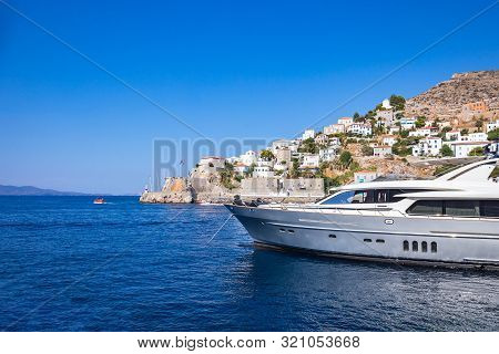 Picturesque View With Yacht At The Port Witj Water Taxi Town Of Hydra Island In Greece