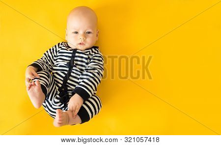 Calm Curious Baby Lying On Bed At Home, Looking At Camera, Top View, Copy Space