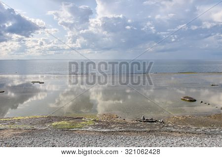 Plain Rock Coast Aith Reflections By The Baltic Sea At The Nature Reserve Neptuni Akrar