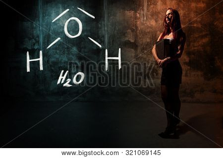Sexy Girl Or Secretary Or Female Student Presenting Handdrawn Chemical Formula Of H2O Water