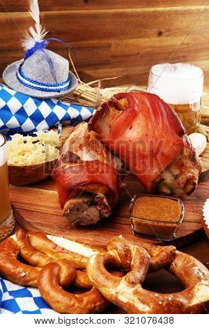 Traditional German Cuisine, Schweinshaxe Roasted Ham Hock. Beer, Pretzels And Various Bavarian Speci