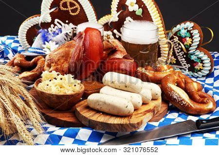Traditional German Cuisine, Schweinshaxe Roasted Ham Hock. Beer, Pretzels And Various Bavarian Speci