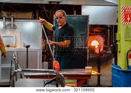 Kalamazoo, Mi/usa - December 4th 2015: Adding Colored Glass To Molten Glass To Give It Some Color