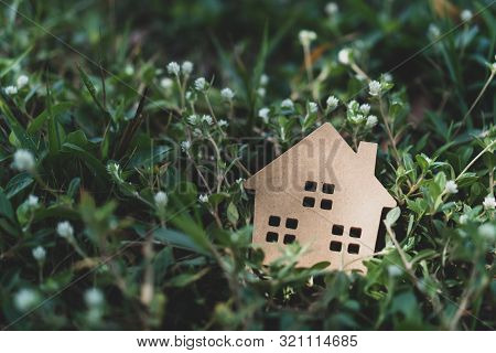 Closed Up Tiny Home Model On Floor Or Wood Board With Grass Background. Deam Life Have Own House Pro