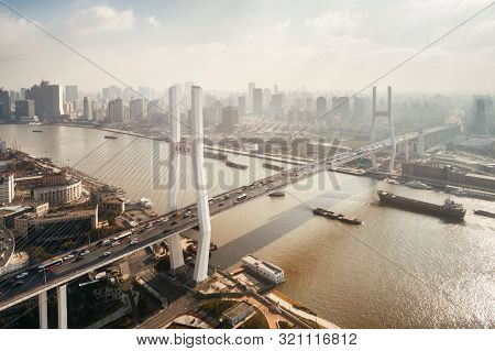 Shanghai Nanpu Bridge over Huangpu River with busy traffic in China.