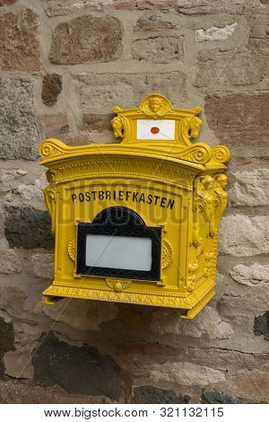 Old Rusty Mailbox On The Timbered Wall