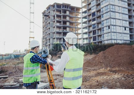 Survey Engineer On The Construction Site And On The Construction Site. Geodesy