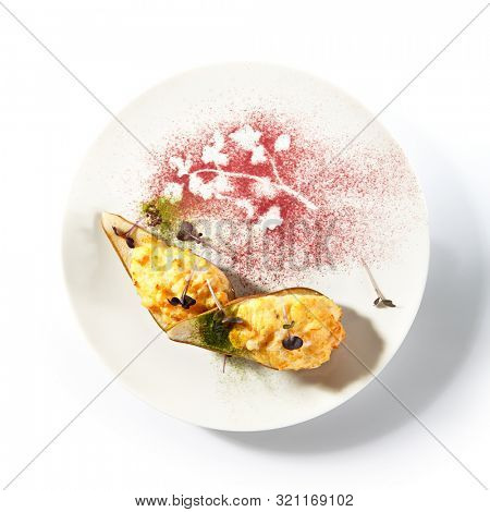 Pear baked with cheese isolated on white background, gourmet restaurant dessert. Roasted halves of pears, cheesy delicious fruit autumn dish top view