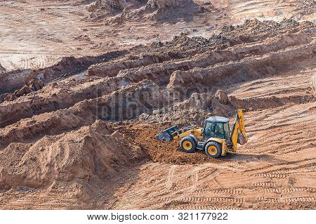 Wheel Loader Excavator Machine Working In Construction Site. Wheel Loader At Sandpit During Earthmov