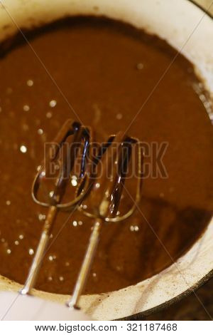 Chokolate Dough For Cake In Cooking Process With Mixer In Bowl Close Up Photo