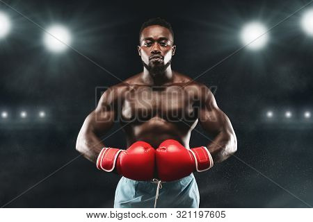 Professional African Boxer Ready To Fight, Staying On Boxing Arena, Stadium Lights Background