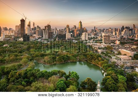 Modern skyscrapers and Lumpini park at sunset in Bangkok downtown, Thailand
