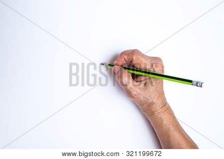 Senior Woman's Hand With Pencil Writing On White Paper