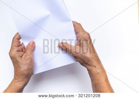 Senior Woman's Hand Folding White Paper On White Background