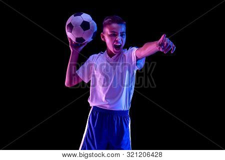 Young Boy As A Soccer Or Football Player In Sportwear Making A Feint Or A Kick With The Ball For A G