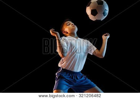 Young Boy As A Soccer Or Football Player In Sportwear Making A Feint Or A Kick With The Ball For A G