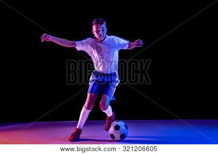 Young Boy As A Soccer Or Football Player In Sportwear Making A Feint Or A Kick With The Ball For A G