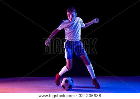 Young Boy As A Soccer Or Football Player In Sportwear Making A Feint Or A Kick With The Ball For A G