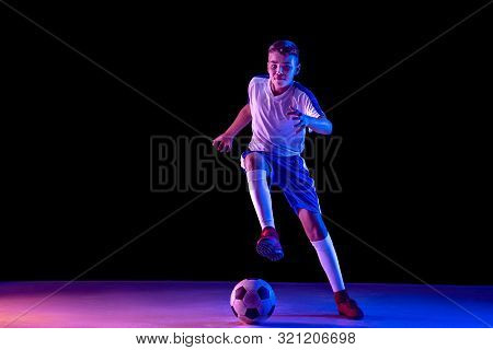 Young Boy As A Soccer Or Football Player In Sportwear Making A Feint Or A Kick With The Ball For A G