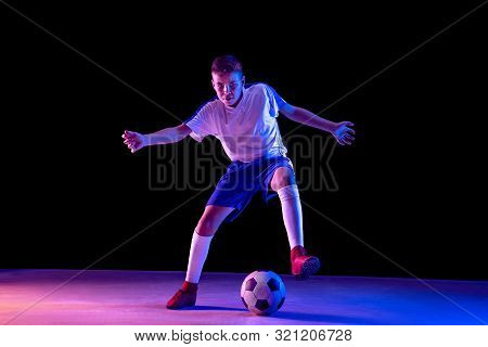 Young Boy As A Soccer Or Football Player In Sportwear Making A Feint Or A Kick With The Ball For A G