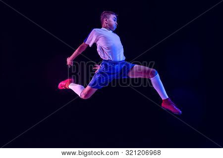 Young Boy As A Soccer Or Football Player In Sportwear Making A Feint Or A Kick With The Ball For A G