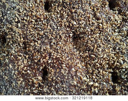 Close-up Of The Outside Of A Fragrant And Delicious Slice Of Finnish Rye Bread In Dark Brown And Bei