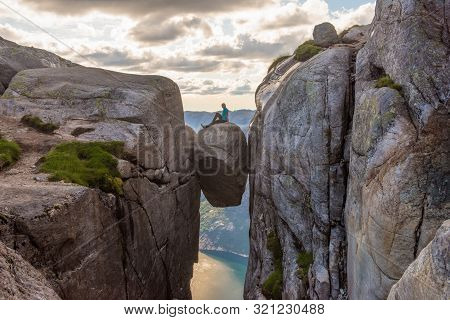 Woman Tourist On Kjeragbolten Raised Hands Travel In Norway Kjerag Mountains Extreme Vacations Adven