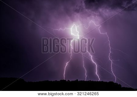 Lightnings Over A Forest Near Morava River During Summer Night Thunderstorm, Slovakia.