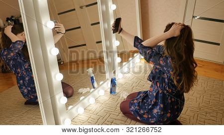 The Girl Sits On The Floor And Makes Selfies At The Makeup Mirrors At Home.