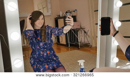 The Girl Sits On The Floor And Makes Selfies At The Makeup Mirrors At Home.