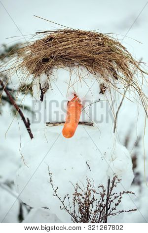 Sad And Ugly Snowman Portrait In Winter