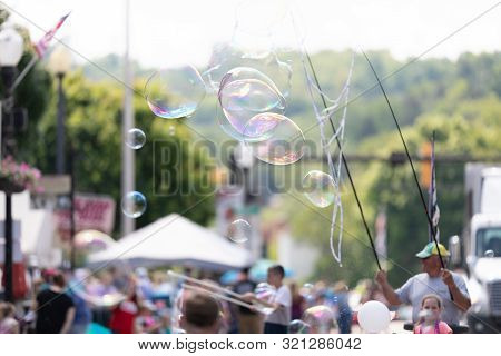 Buckhannon, West Virginia, Usa - May 18, 2019: Strawberry Festival, Man Creating Larg Bubbles For Ch