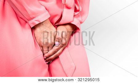 Gynecologic Problems, Urinary Incontinence, Female Health. Woman Holds Hands Between Her Legs