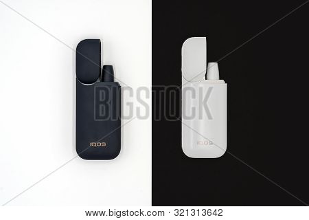 White Iqos Device Battery And Black Iqos Device Battery Isolated On White And Black Background. Russ