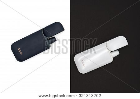 White Iqos Device Battery And Black Iqos Device Battery Isolated On White And Black Background. Russ