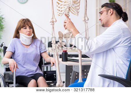 Young woman in wheel-chair visiting male doctor 