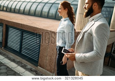 Business People Talking, Smiling And Discussing Ideas Outside.