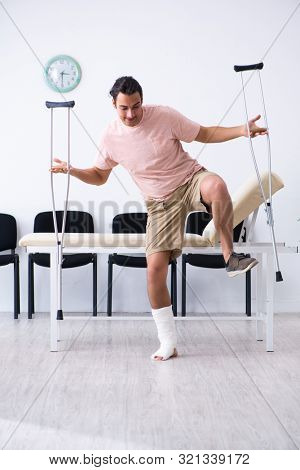 Young injured man waiting for his turn in hospital hall