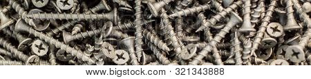 Banner Of Tapping Screws Made Of Steel For Construction As A Background.