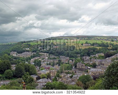 An Aerial View Of The Town Of Hebden Bridge In West Yorkshire Surrounded By Pennine Hills And Fields