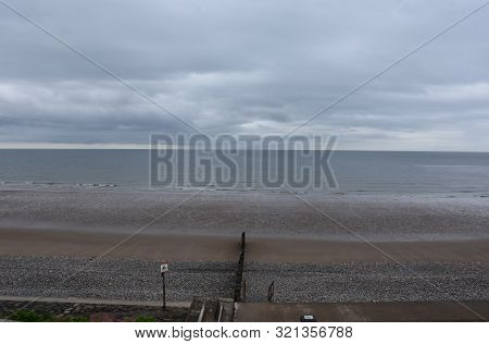 Waves Gently Rolling Ashore On The Beach In St Bees.
