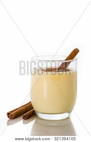Homemade Eggnog With Cinnamon In Glass Isolated On White Background. Typical Christmas Dessert.