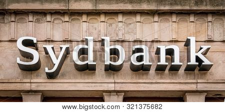 Sign Of The Danish Sydbank In White Letters On A Brownish Facade In Svendborg, Denmark, July 10, 201