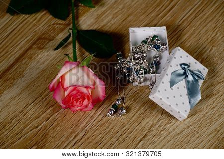 Dolce Vita Roses With Dotted White Present Box On Wood Background
