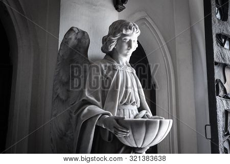Angelic Statue Holding The Bowl For Holy Water In San Beda Mendiola.