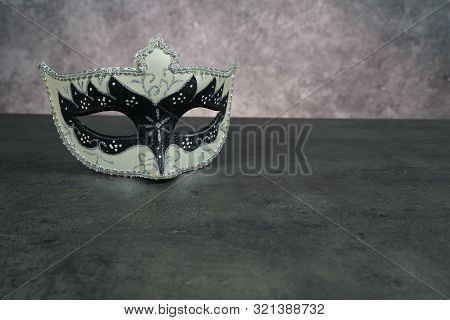 Photo Of Elegant White And Black Venetian, Carnaval Mask Over Dark Background. Vintage Photo