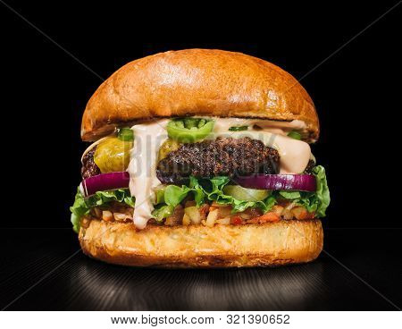 Craft Burger Is Cooking On Black Background. Consist: Sauce Salsa, Lettuce, Red Onion, Pickle, Chees