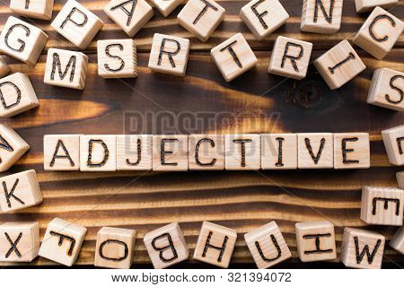 Word Adjective Composed Of Wooden Cubes With Letters, Part Of Speech Concept Scattered Around The Cu