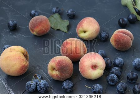 Peaches And Berry Blackthorn Are Located On A Dark Background In Random Order, Horizontal Orientatio
