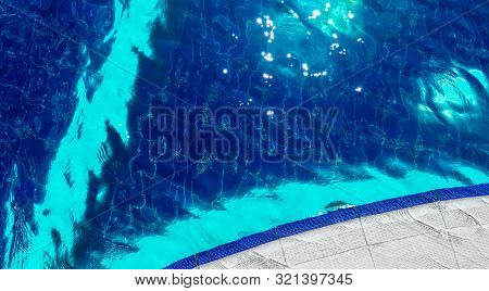 Sparkling Water On The Sun, Outdoor Swimming Pool With Blue Tile On The Bottom. Summer, Water Fun Co